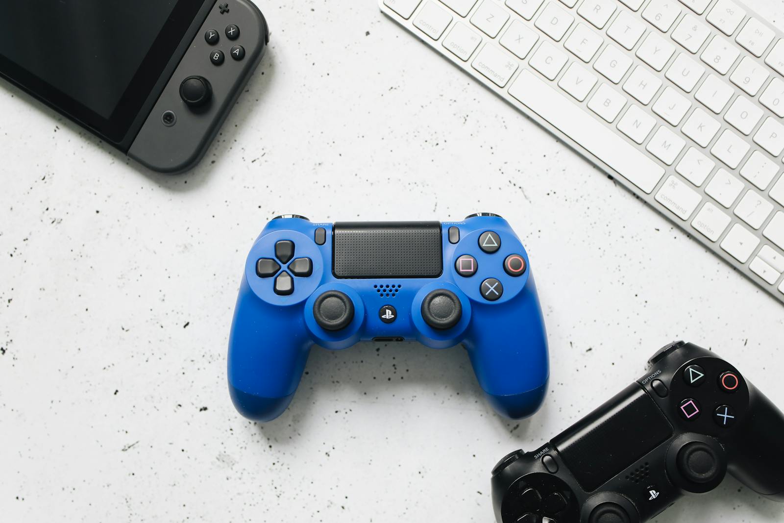 The desk of a video game blogger with keyword, nintendo switch and game controllers